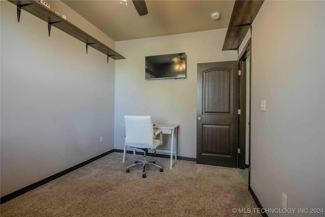 carpeted office featuring ceiling fan