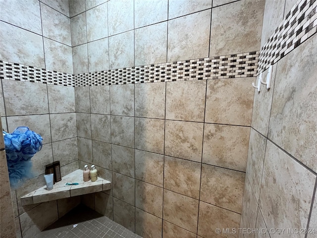 interior details with a tile shower