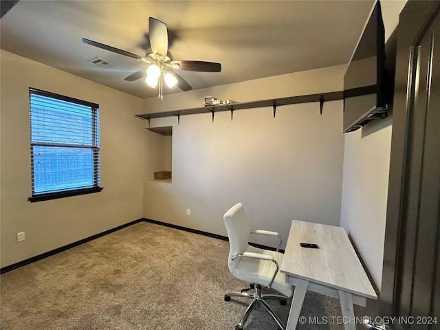 unfurnished office featuring light carpet and ceiling fan