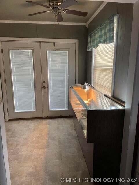 doorway to outside featuring ceiling fan, crown molding, and french doors