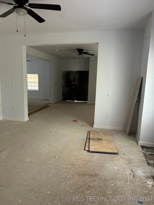 unfurnished living room with ceiling fan