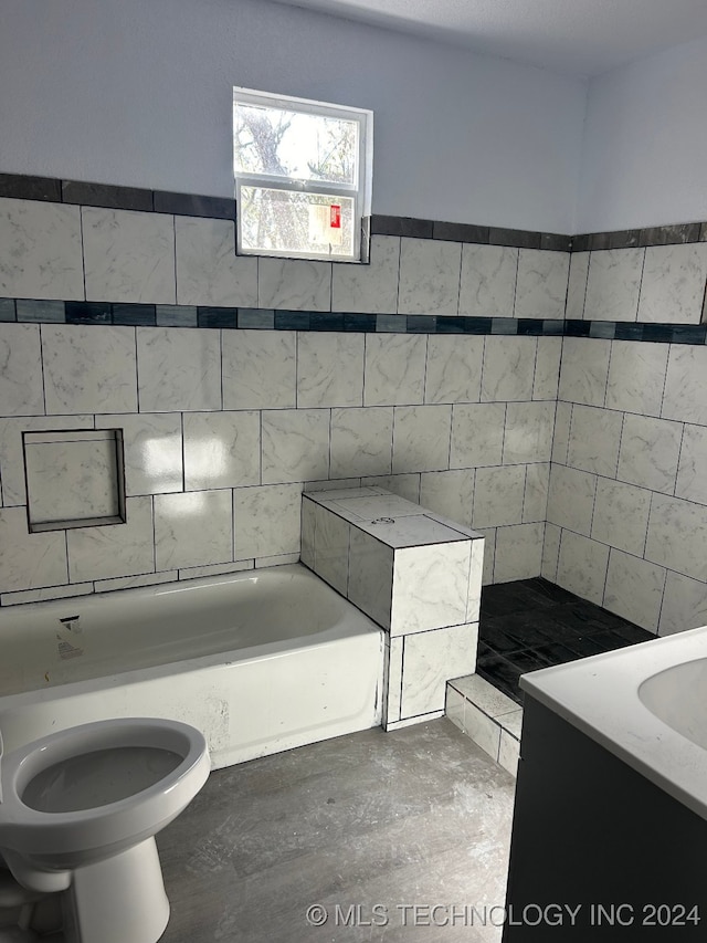 bathroom featuring vanity, a bath, toilet, and tile walls