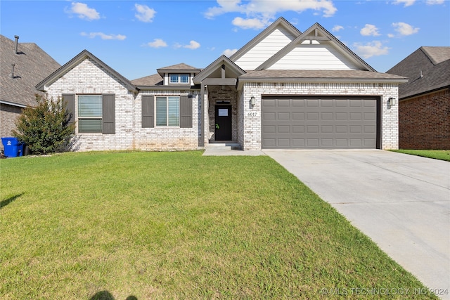 view of front of home with a garage and a front lawn