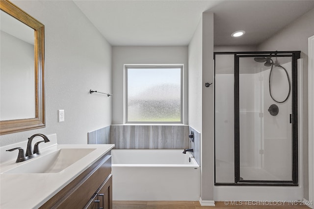 bathroom with vanity, independent shower and bath, and wood-type flooring