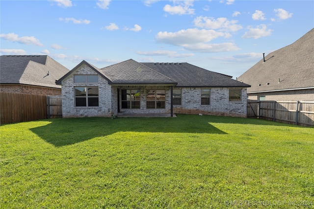 back of house with a yard