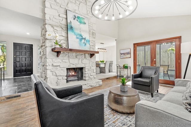 living room featuring a fireplace, wood-type flooring, french doors, and high vaulted ceiling