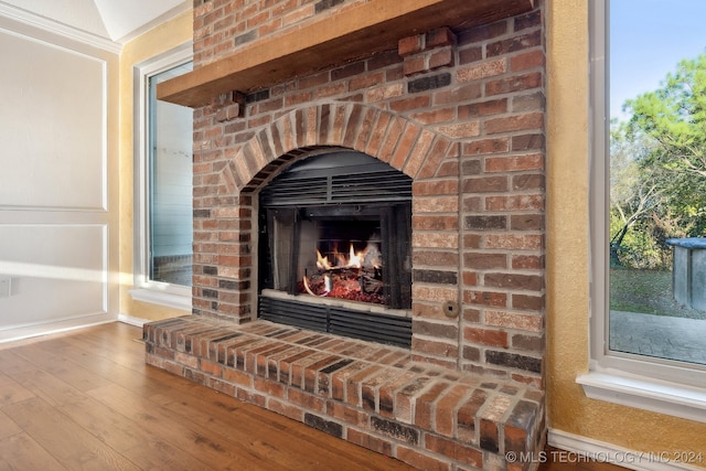 room details featuring a fireplace and wood-type flooring