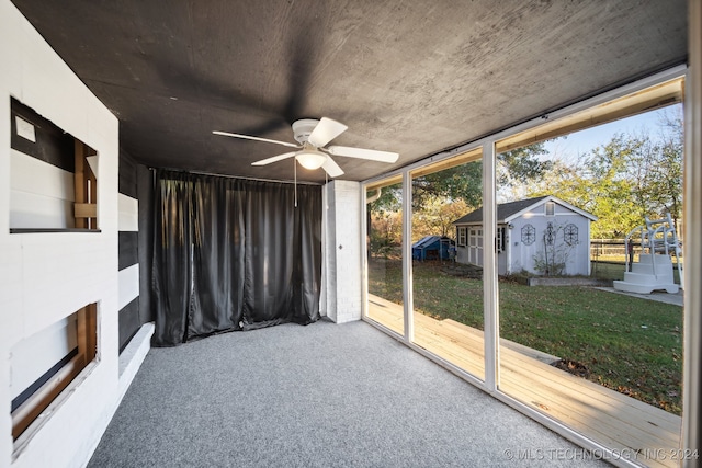 unfurnished sunroom with plenty of natural light and ceiling fan