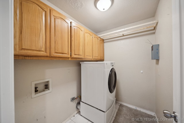 washroom with cabinets and washer / dryer