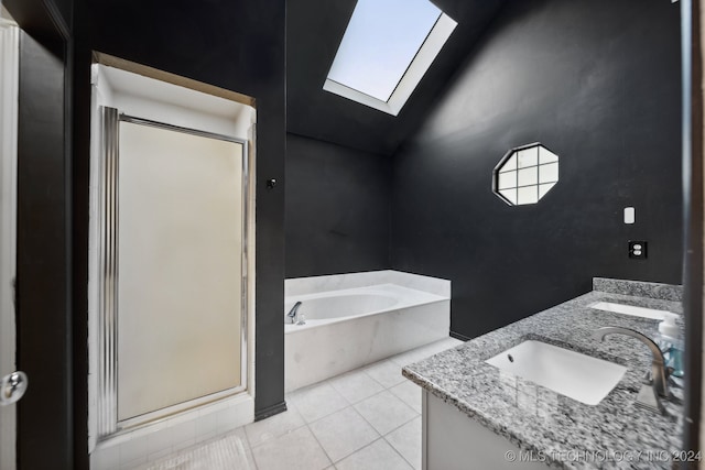 bathroom with tile patterned flooring, vanity, lofted ceiling with skylight, and separate shower and tub