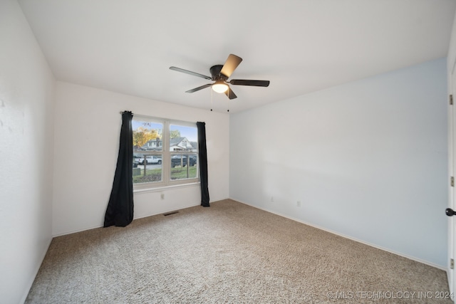 spare room with ceiling fan and carpet