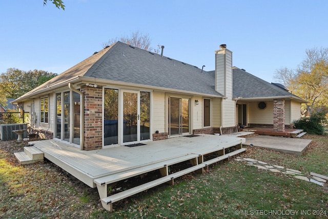 rear view of house with central AC unit and a deck