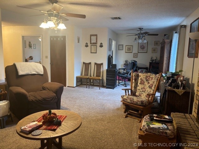 carpeted living room with a textured ceiling and ceiling fan