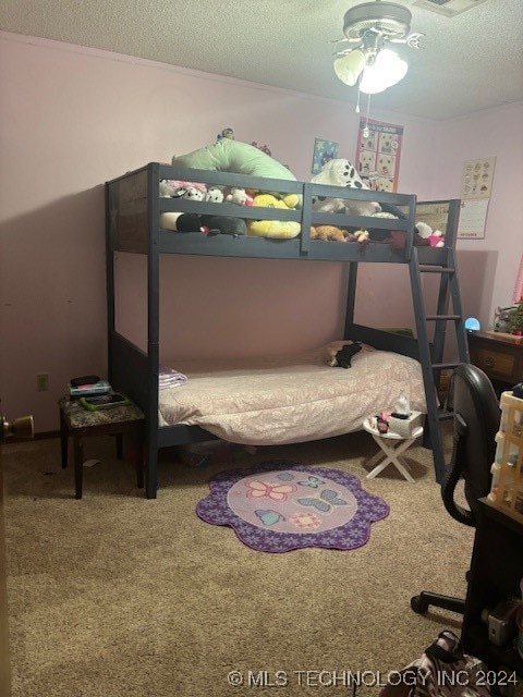 bedroom with carpet and a textured ceiling