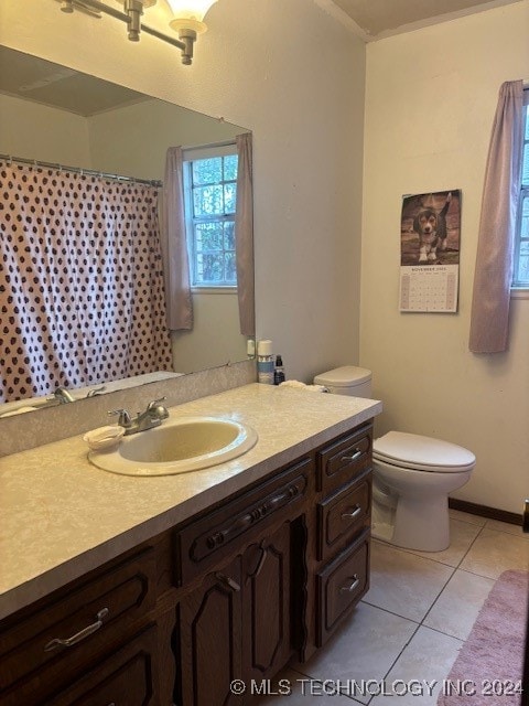 bathroom featuring tile patterned flooring, vanity, and toilet