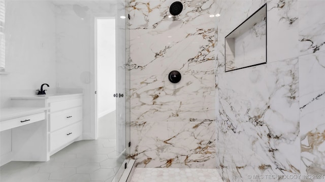 bathroom featuring vanity and a tile shower