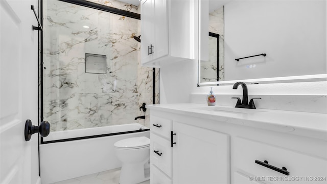 full bathroom with vanity, bath / shower combo with glass door, and toilet