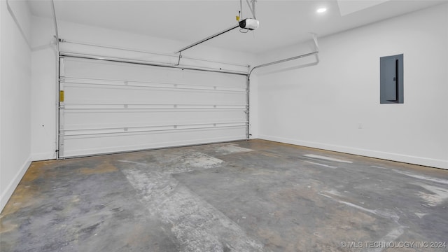 garage with electric panel and a garage door opener