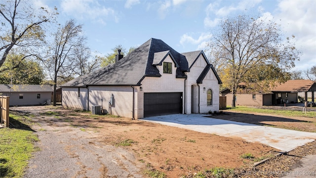 view of property exterior featuring a garage and central air condition unit