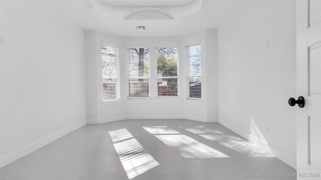 tiled empty room with a healthy amount of sunlight