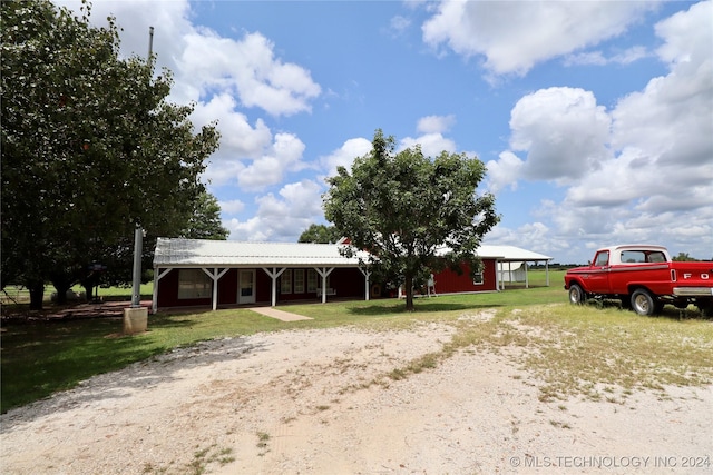 view of front of home with an outbuilding and a front yard