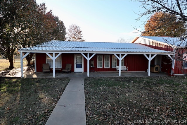 3998 E 173rd St S, Warner, OK 74469 - exterior space featuring board and batten siding, covered porch, a front yard, and metal roof