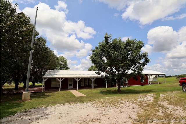 exterior space with an outdoor structure and a lawn