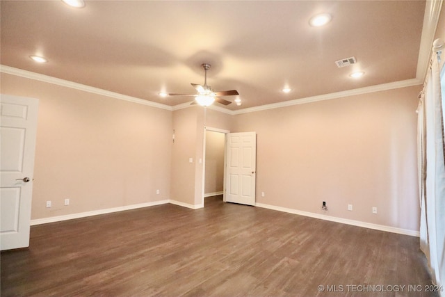 unfurnished room featuring visible vents, dark wood-type flooring, baseboards, and ornamental molding