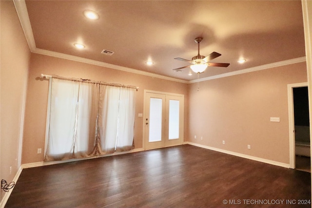 unfurnished room with visible vents, dark wood-type flooring, baseboards, and ornamental molding