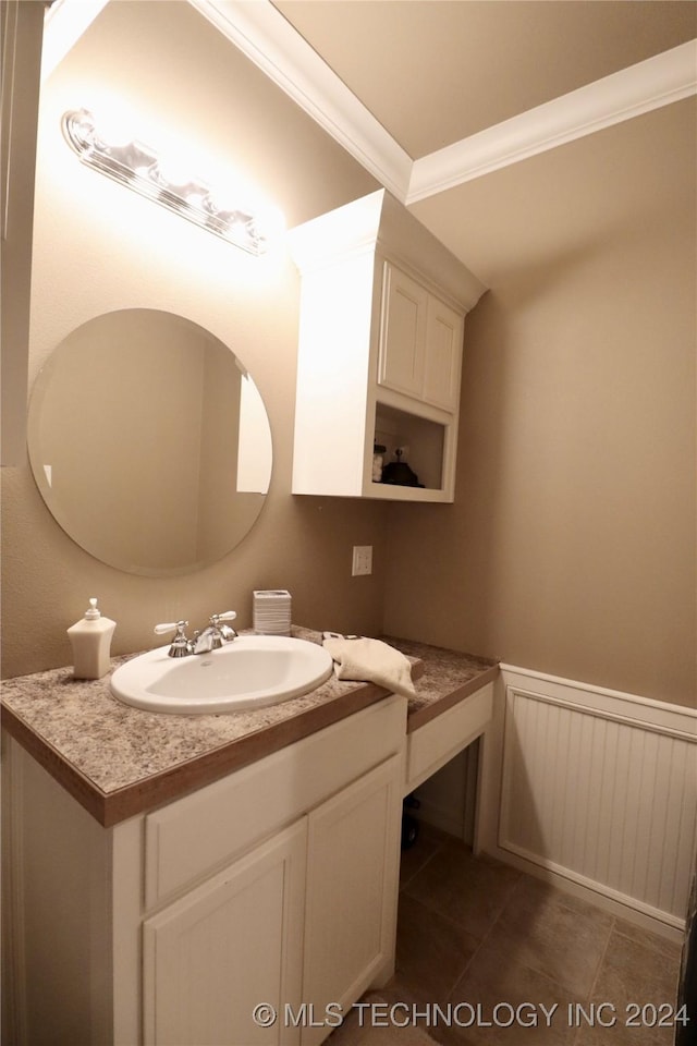 bathroom featuring a wainscoted wall, ornamental molding, vanity, and tile patterned flooring