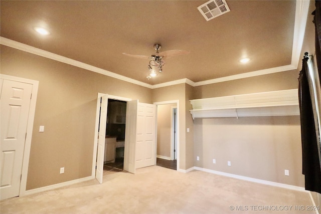 unfurnished bedroom featuring baseboards, carpet, visible vents, and ornamental molding