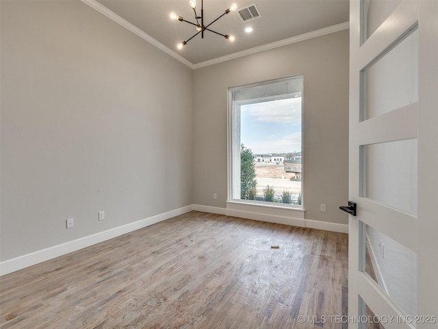 unfurnished room featuring a healthy amount of sunlight, light hardwood / wood-style flooring, crown molding, and an inviting chandelier