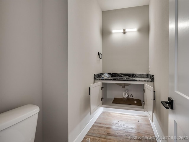 bathroom featuring toilet and hardwood / wood-style floors