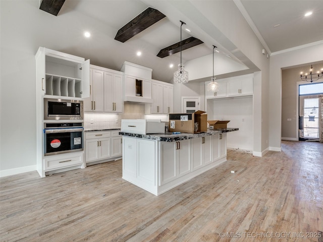 kitchen with decorative light fixtures, decorative backsplash, beamed ceiling, appliances with stainless steel finishes, and white cabinets