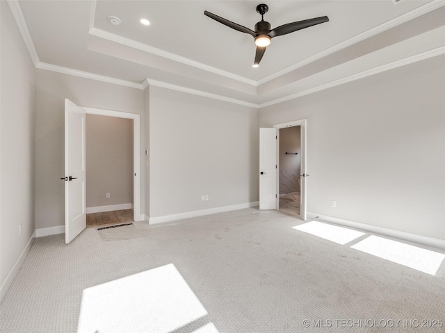 unfurnished bedroom featuring light carpet, ceiling fan, crown molding, and a tray ceiling