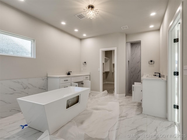 bathroom with a bath and vanity