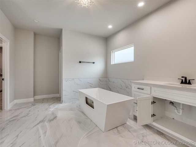 bathroom with tile walls, vanity, and a bathing tub