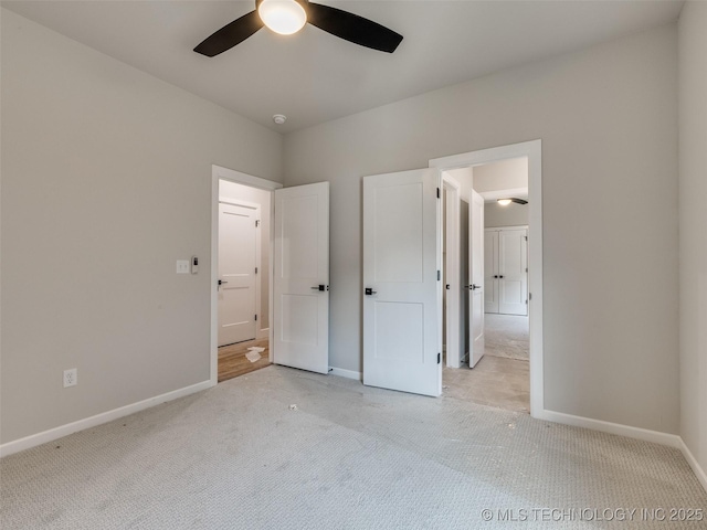 unfurnished bedroom with ceiling fan and light carpet