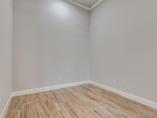 unfurnished room featuring crown molding and light hardwood / wood-style flooring