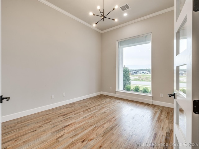 empty room with baseboards, visible vents, light wood-style floors, a chandelier, and crown molding