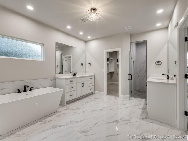 full bath featuring a marble finish shower, two vanities, a sink, recessed lighting, and marble finish floor