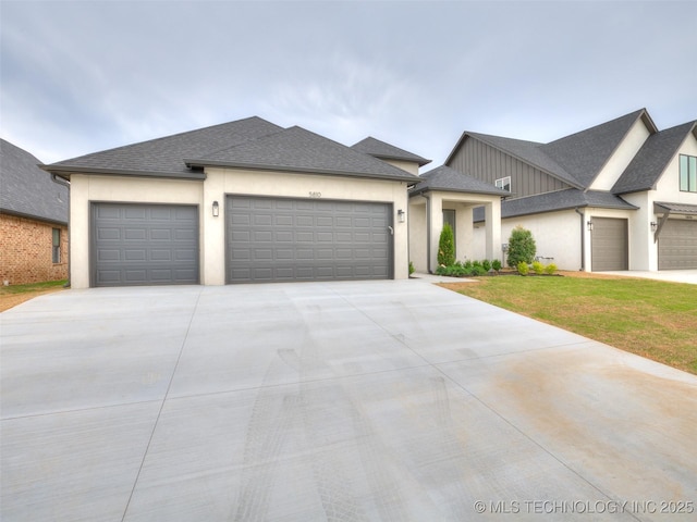 view of front of house with an attached garage, driveway, stucco siding, and roof with shingles