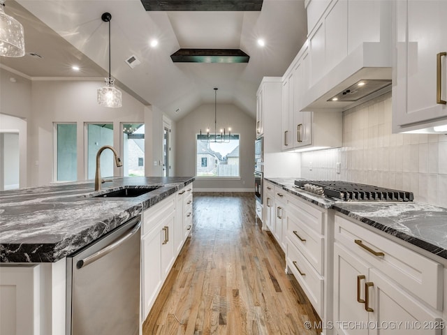 kitchen with custom exhaust hood, a sink, light wood-type flooring, white cabinets, and appliances with stainless steel finishes