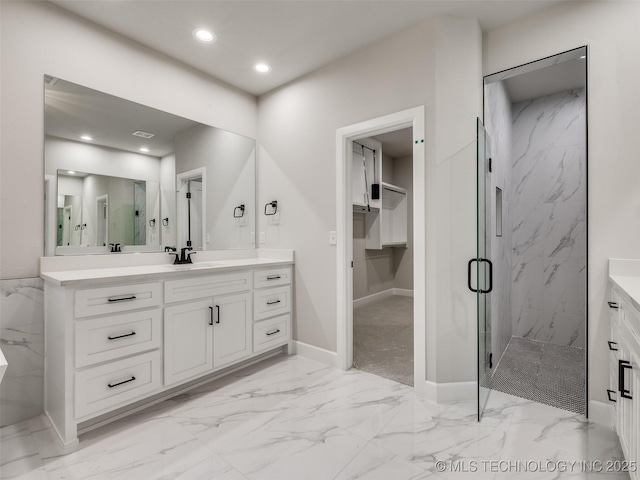 full bathroom featuring a marble finish shower, baseboards, recessed lighting, marble finish floor, and vanity