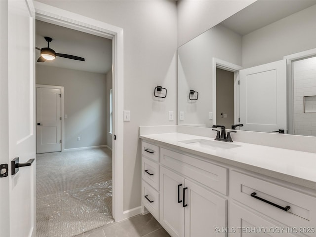 bathroom with baseboards, vanity, and ceiling fan
