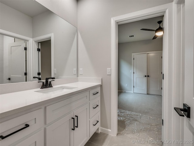 bathroom with baseboards, visible vents, a ceiling fan, and vanity