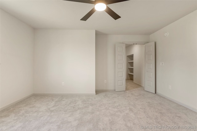 unfurnished bedroom with ceiling fan and light carpet