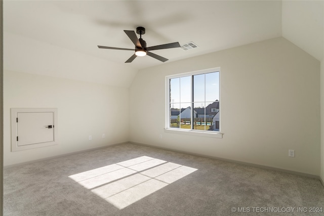 additional living space featuring ceiling fan, light colored carpet, and lofted ceiling