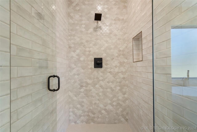 bathroom with a shower with door