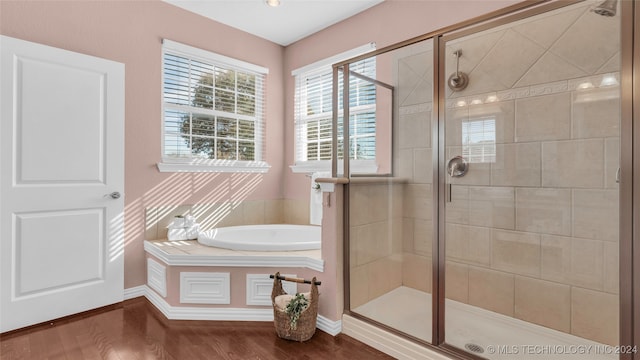 bathroom featuring hardwood / wood-style floors and separate shower and tub